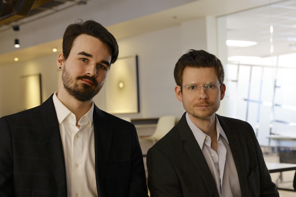 Cofounders Tyler Hurst and Henry Popp in an office atrium